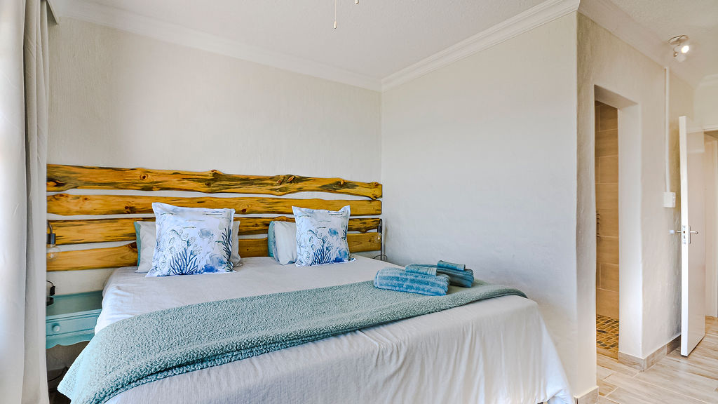 The large bed of the main bedroom in the two bedroom apartment.